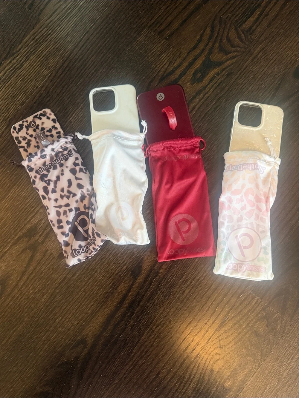 Loopy Case iPhone 15 pro Grip & Pouch Set in Red, 2 White, and tortoise.